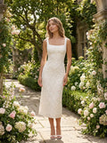 Female model wearing the floral lace square-neck A-line midi dress in a garden setting