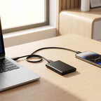 Portable 128GB SSD drive on a modern desk with laptop