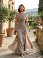 Model wearing draped cowl-neck maxi dress, full-body lifestyle photo