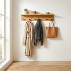 Bamboo wall coat rack with shelf and hooks mounted in a bright modern entryway