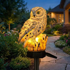 Solar owl garden light on pathway at dusk