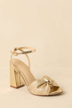 Women's Charmed I'm Sure Gold Woven Bow Block Heel Sandals | Heel measures 3.75" 3