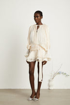 Eugénie – Long Sleeve Mini Dress with Ruffled Hem & Glitter Detail