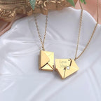 Gold Love Letter necklace on plate
