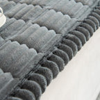 Plush pleated-edge sofa cover detail
