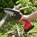 Cordless mini chainsaw pruning a branch