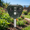 Solar ultrasonic bird repeller in a garden