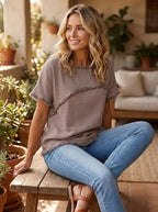 Model in fringed short-sleeve top