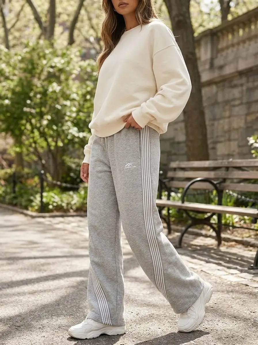 Model wearing retro-stripe loose-fit joggers in an active casual setting