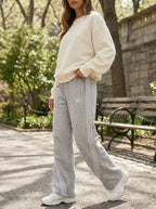 Model wearing retro-stripe loose-fit joggers in an active casual setting
