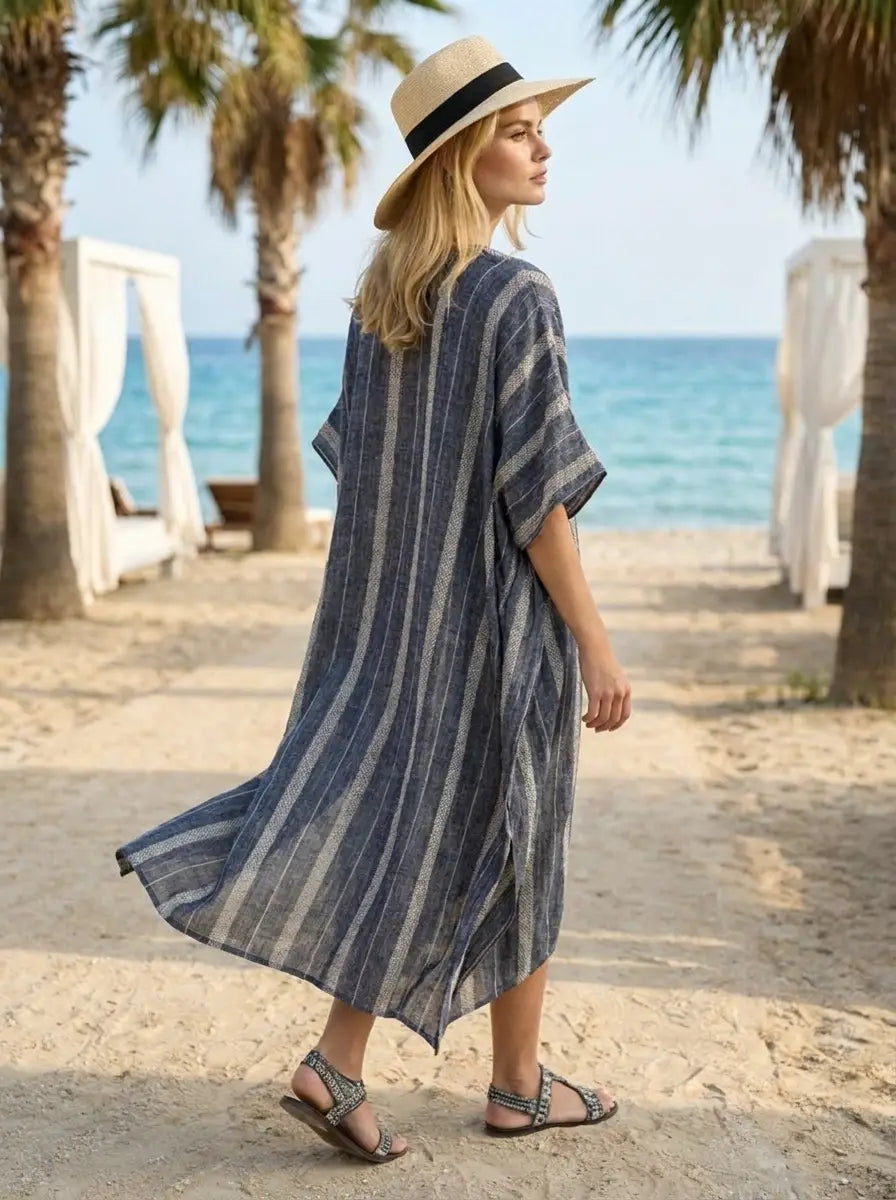Model wearing the striped lightweight kaftan maxi dress in a beach resort setting