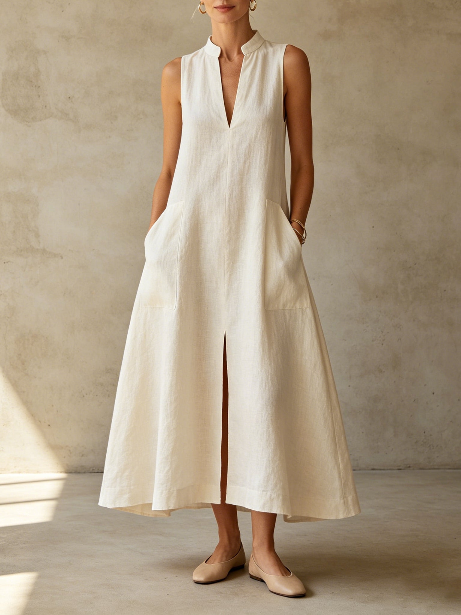 Off-white stand-collar sleeveless linen maxi dress with front slit and pockets