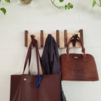 Wooden piano-shaped coat rack in walnut wood