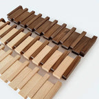 Wooden piano-shaped coat rack mounted on wall