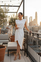 White sleeveless asymmetric dress with padded shoulders and a draped skirt.
